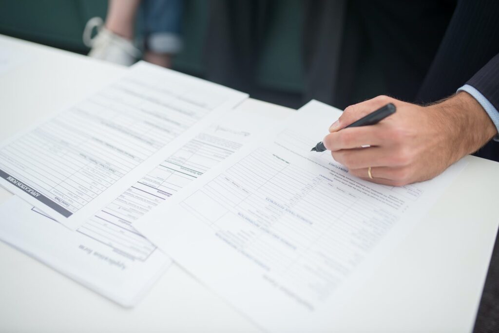 Person Holding White Printer Paper